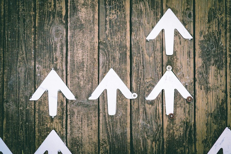 Arrows pointing upwards illustrating your search engine boost through SEO article writing