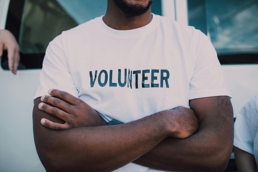 Image of a volunteer with their arms crossed
